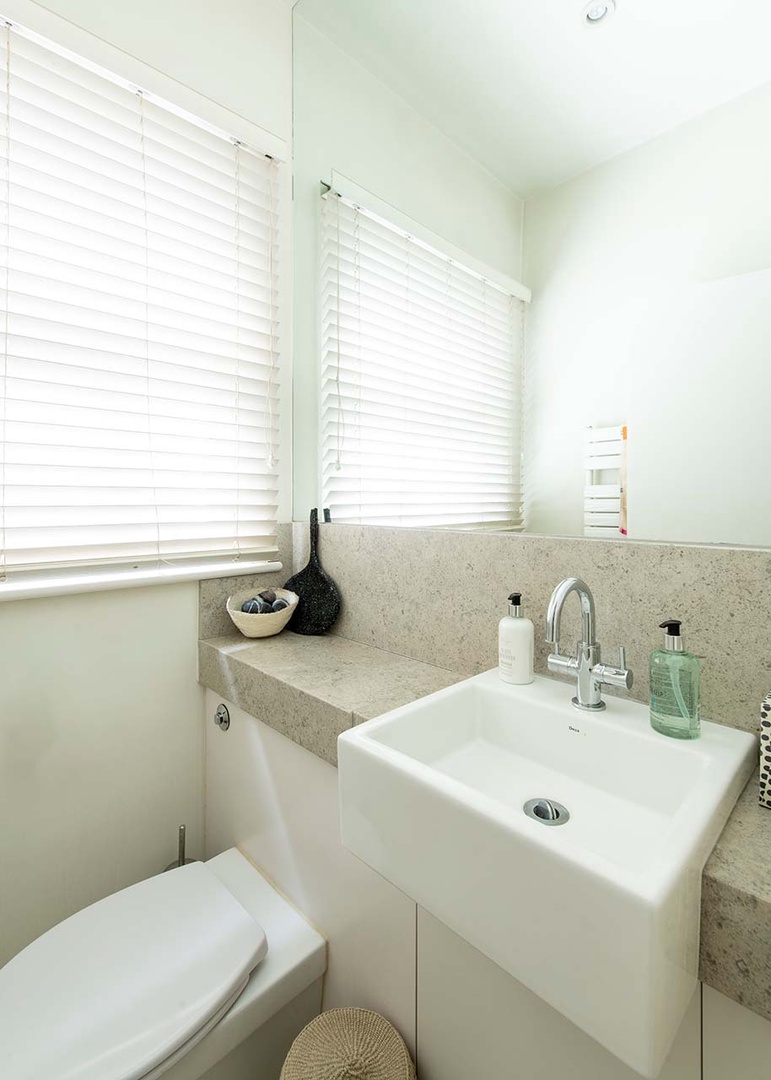 Half bath located on landing between kitchen and living room.