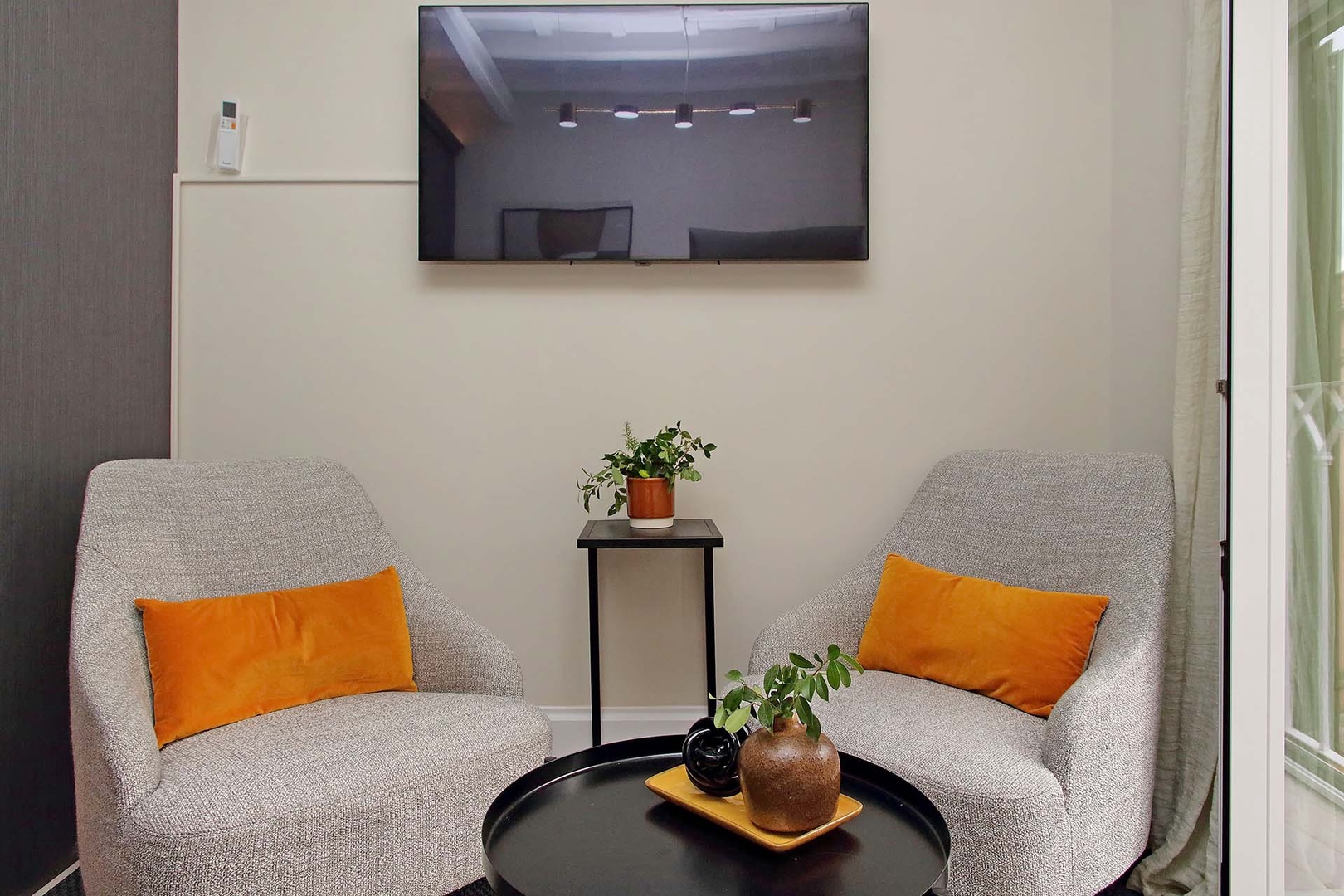 Large wall-mounted TV in living area.