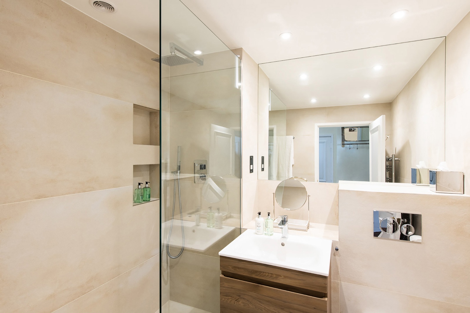 Large mirrors and storage in the bathroom.