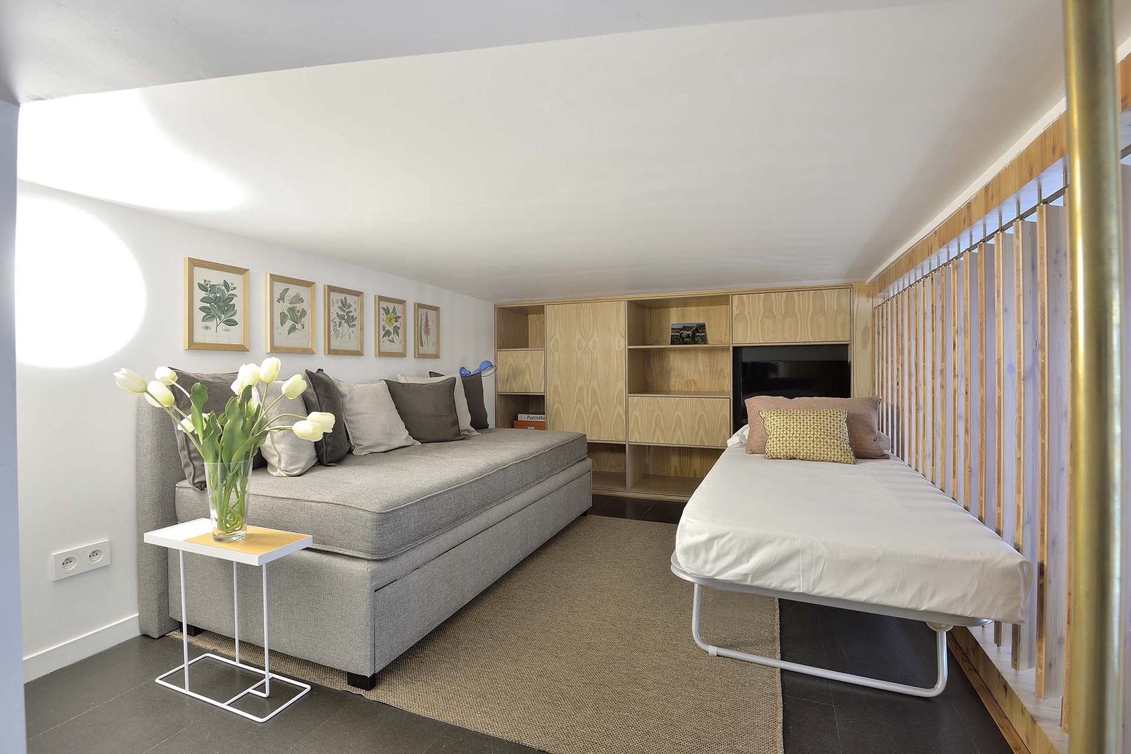 The sofa on the mezzanine can also be used for extra sleeping space.