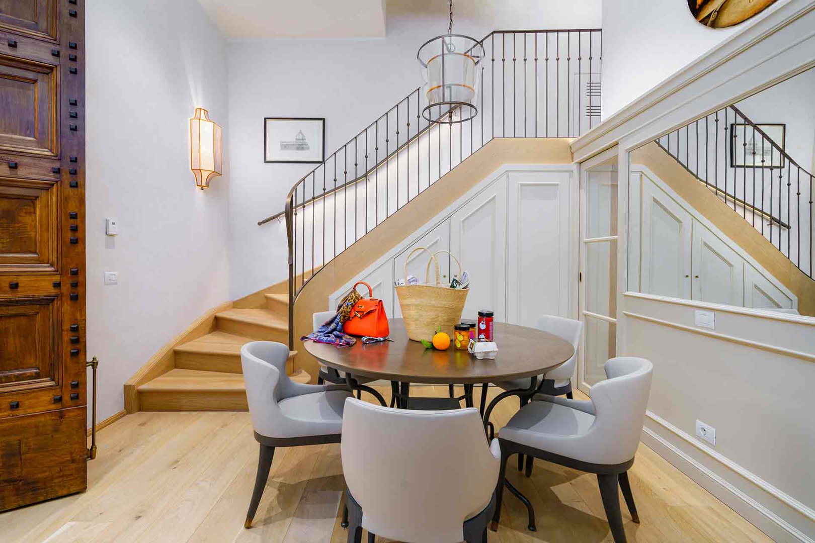Step into your bright, two-story entryway where a welcoming dining table invites you to gather for morning coffee.