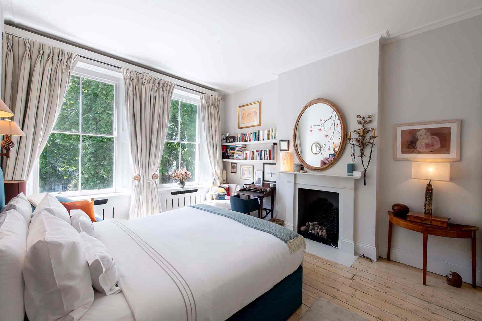 Beautiful English bedroom with antiques and desk.