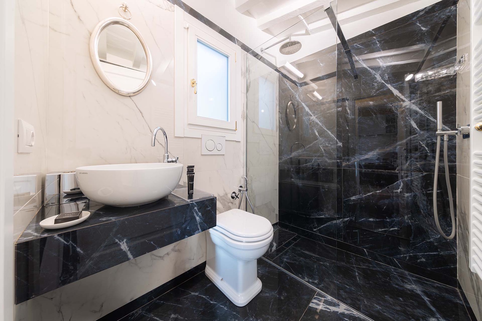 Large shower with rainwater and flexible showerheads.