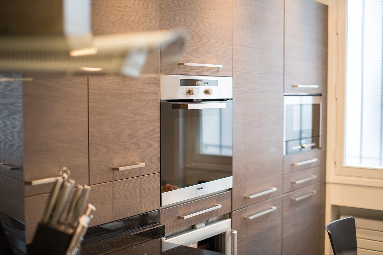 A high-end oven, microwave, fridge and wine fridge are built into the kitchen design.