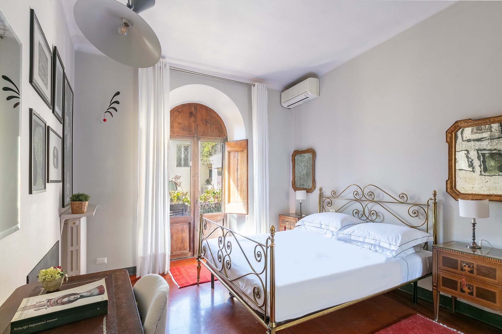 Bedroom 1 has a sweet little balcony overlooking the courtyard.