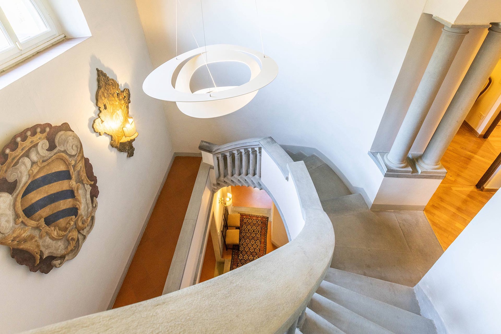 Graceful curved staircase of pietra serena from Fiesole leads to the upper floors.