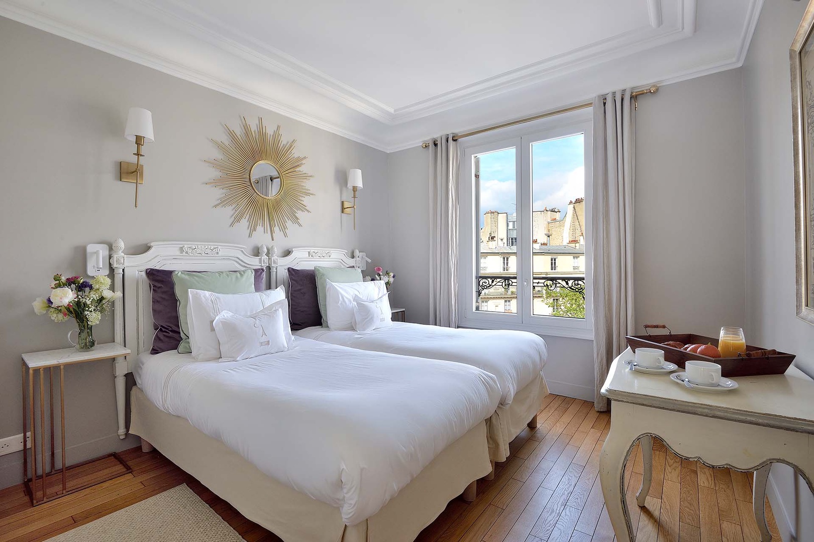Bedroom 2 has comfy beds and an Eiffel Tower view.