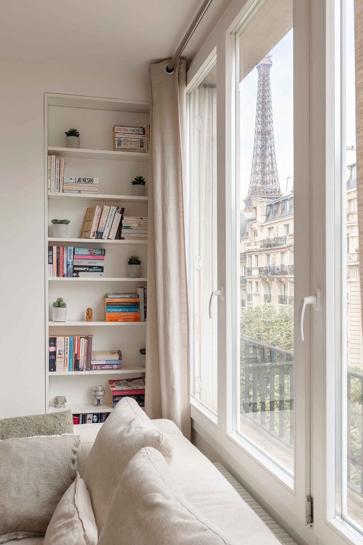 Sunlit windows with the Eiffel Tower peeking from the left.