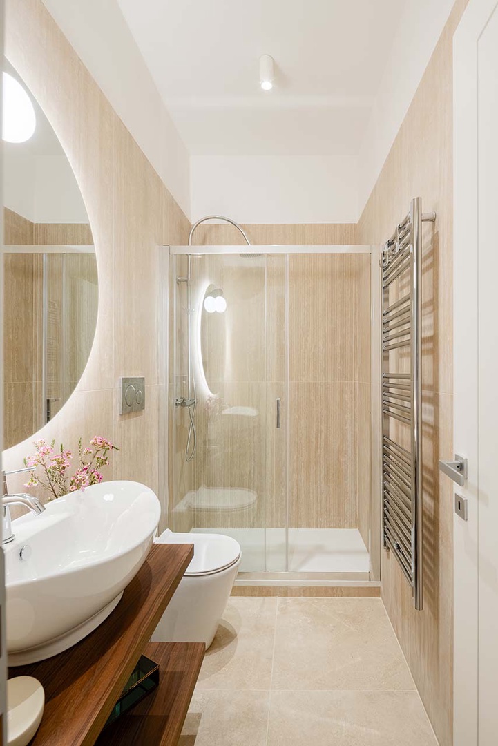 Glass enclosed shower and elegant design.