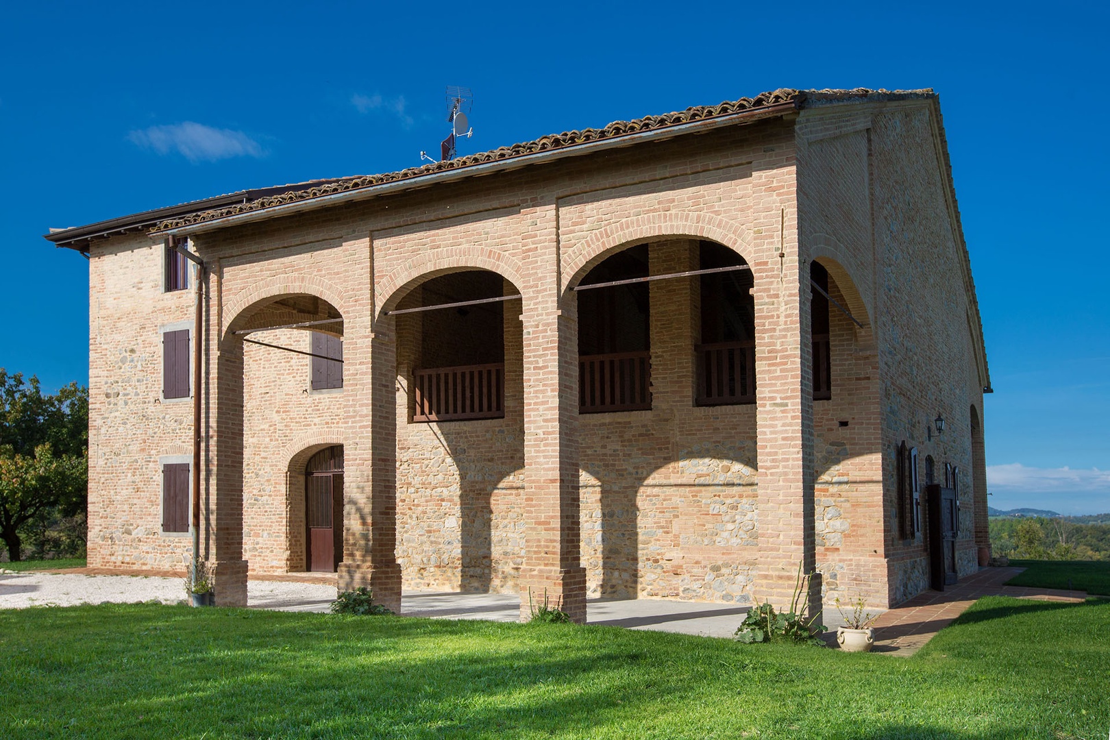 The front of the building has a covered terrace that mirrors the one on the back of the villa.