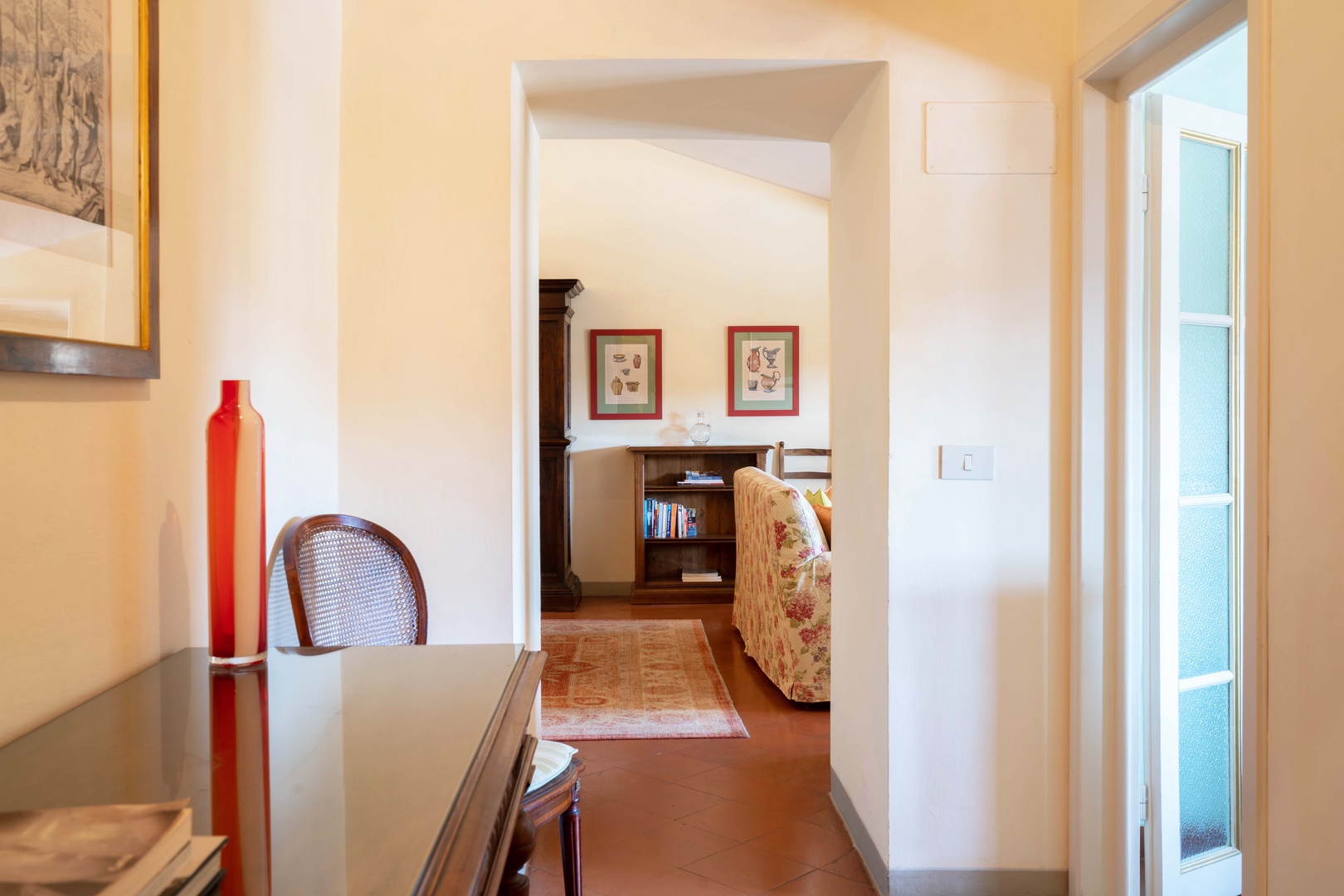 The entry hallway with Italian floor tiles leads to the living room.
