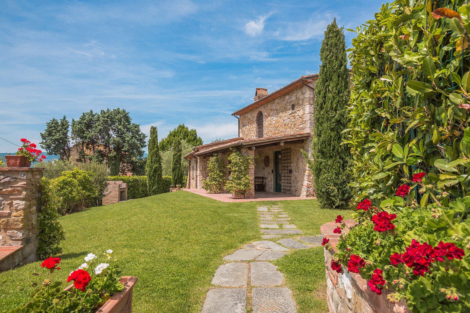 Iconic Tuscan cypress trees greet you at the entrance.