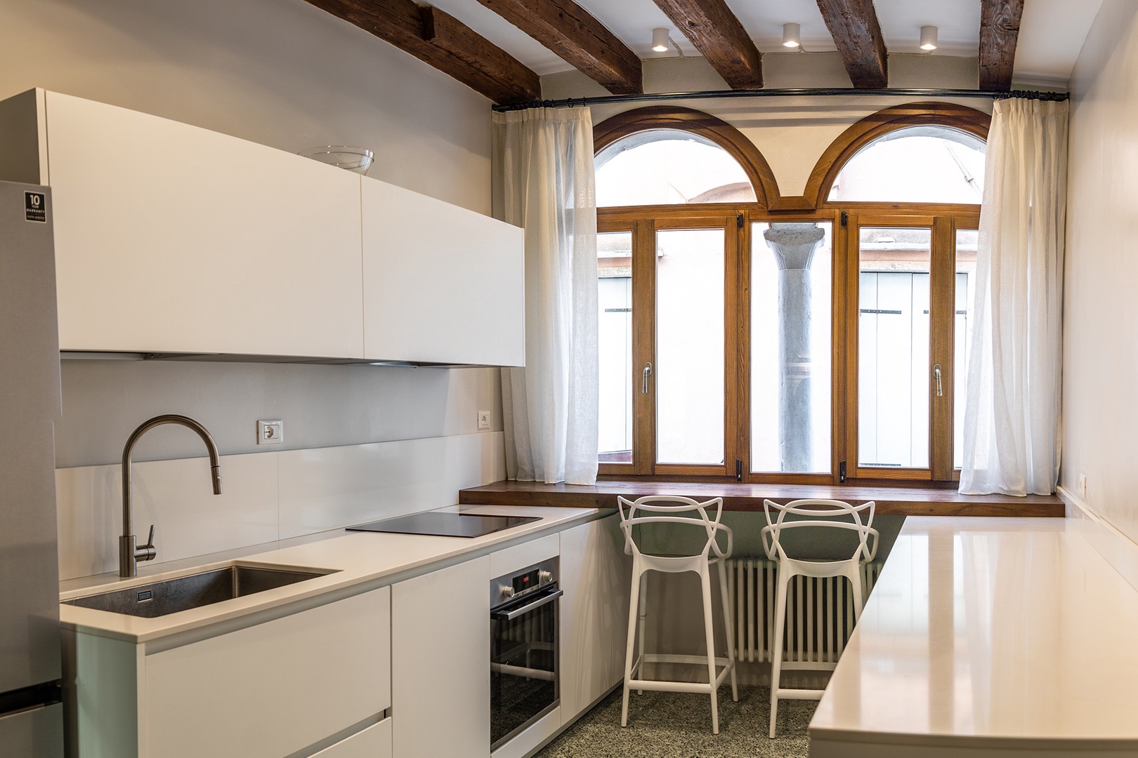 Modern kitchen with original ceiling beams and Venetian Terrazzo floor