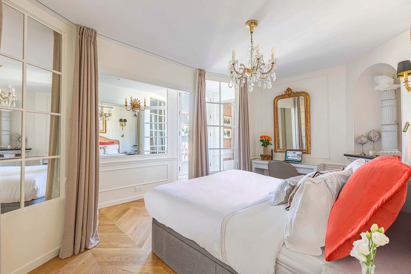 Sink into plush bedding beneath a sparkling chandelier,