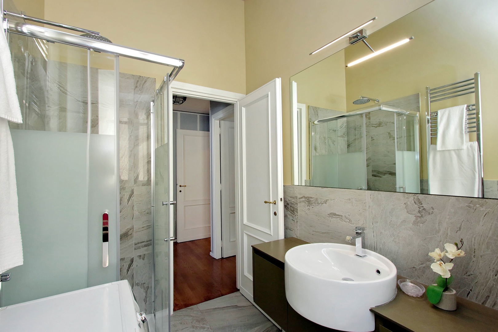 Bathroom 2 has fully enclosed glass shower with rainfall showerhead.