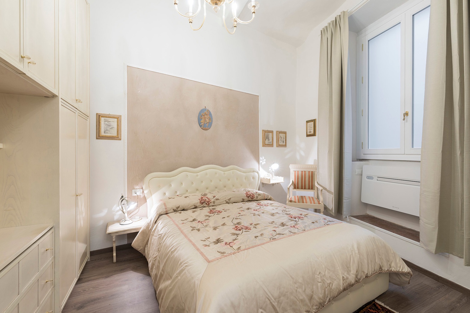 Elegantly furnished bedroom 1 has a large plush bed.