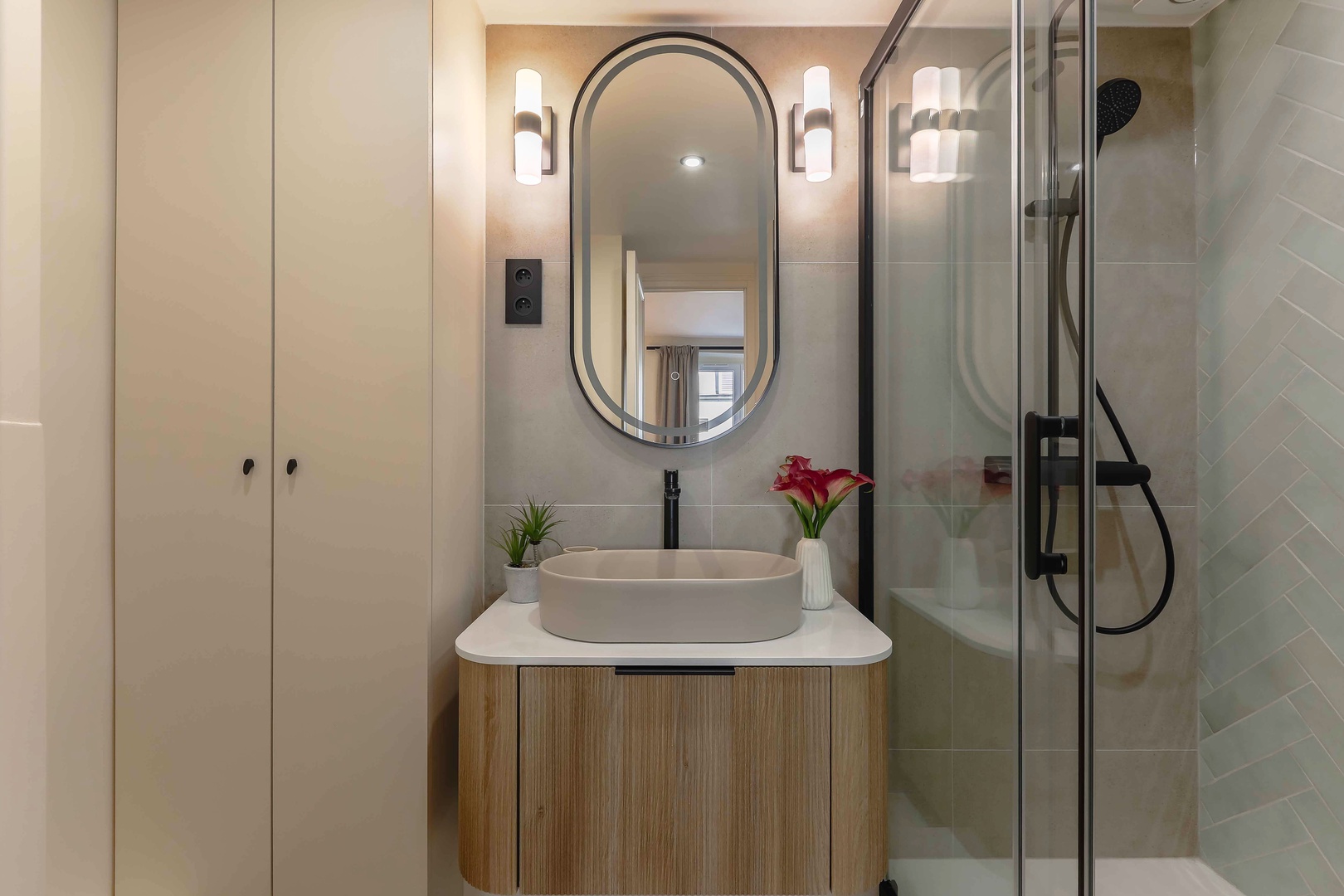 Stylish bathroom with toilet, sink and large shower.