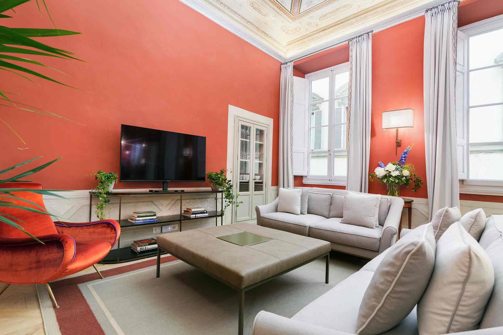 Settle into the elegant living room with soaring ornate ceilings.