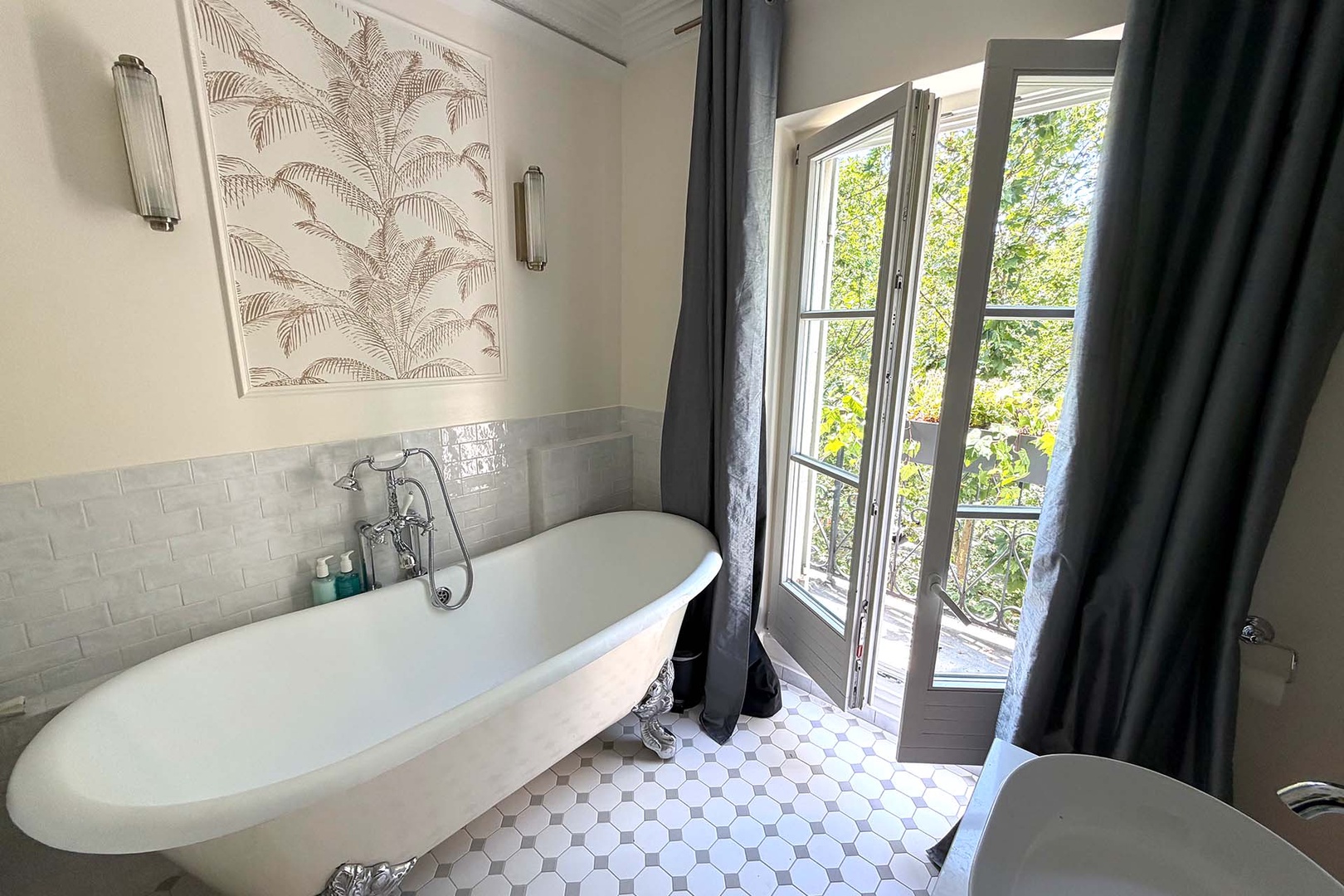 Bathroom 1 features a claw footed bathtub with Eiffel Tower views.