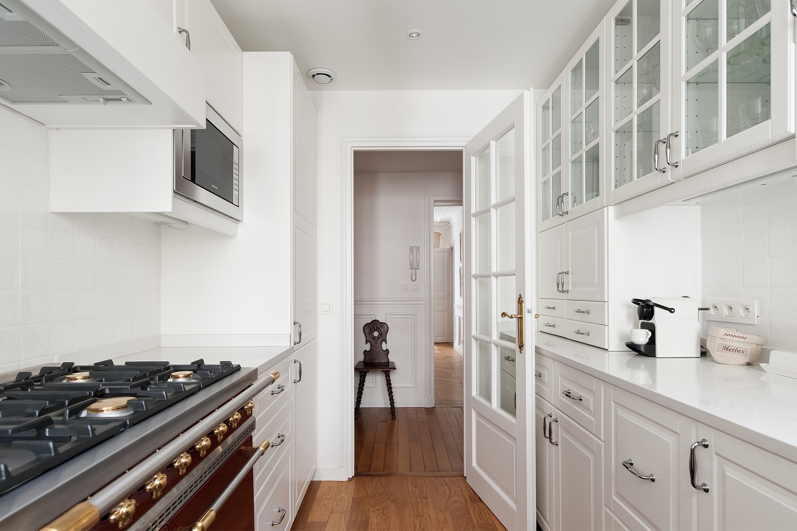 The kitchen features a vintage-style gas stove top and oven.