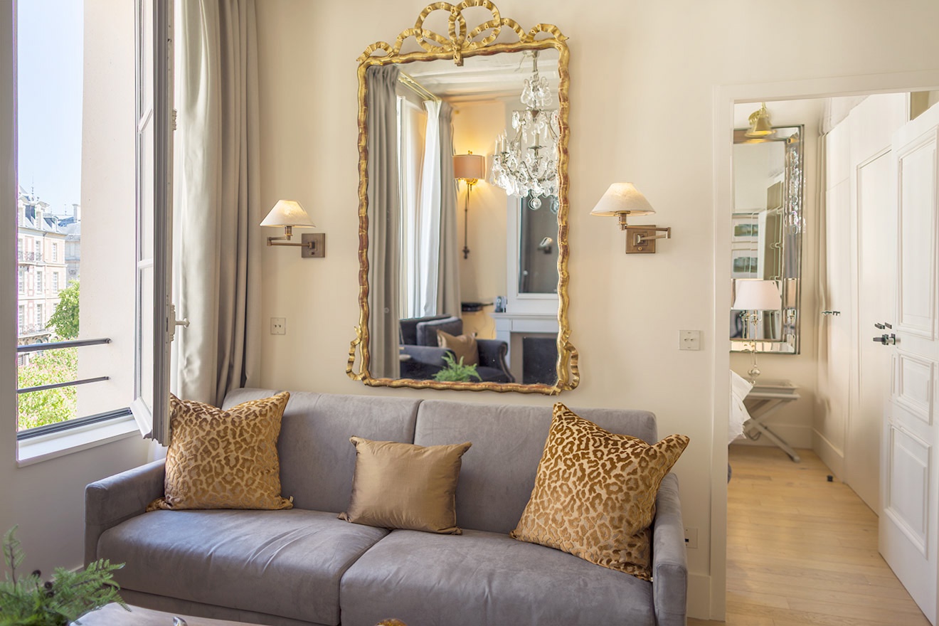 Enjoy views of Place Dauphine from the elegant sofa.