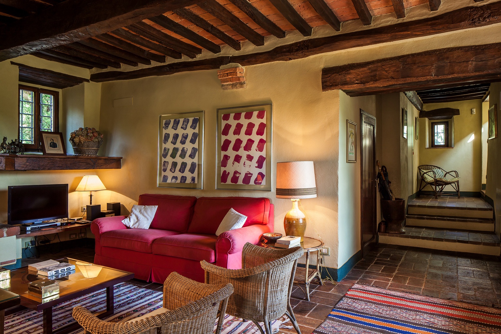 Eclectic artwork, kilim carpets and fabulous beamed ceilings add interest and architectural charm.