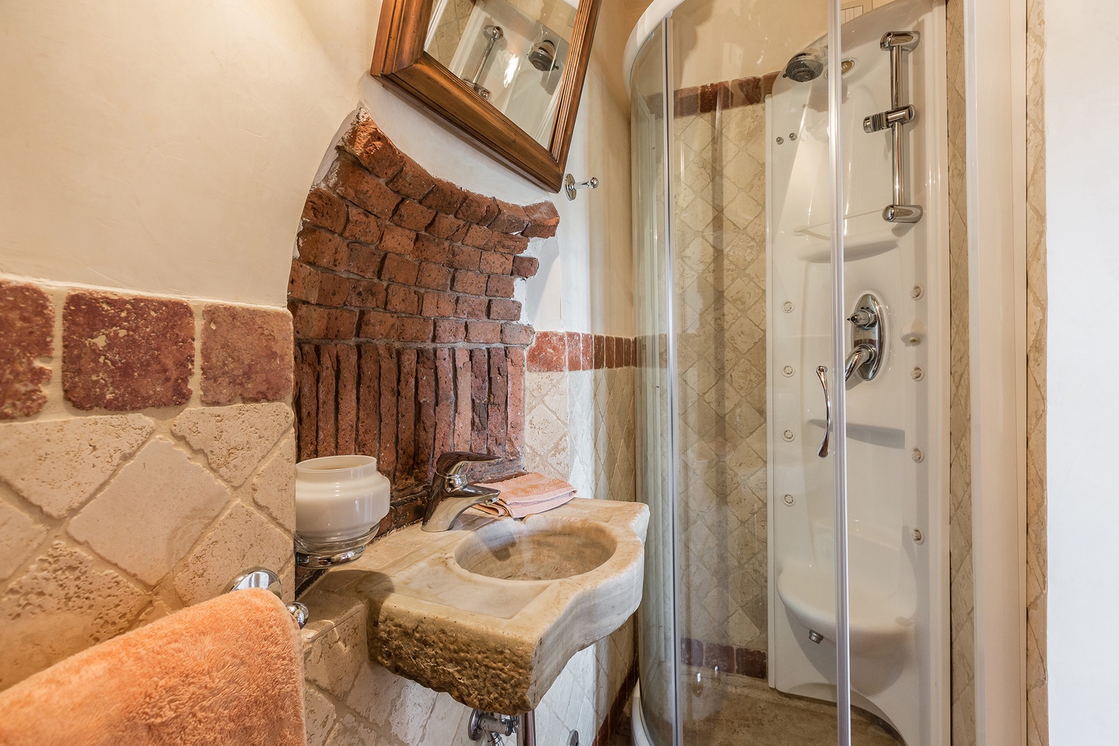 This bathroom adjoins the small dining room. Interesting brickwork above sink.