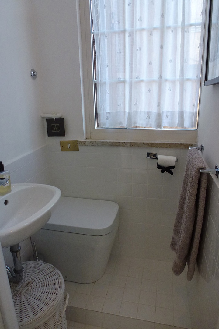 Half bath with toilet next to bedroom 1.