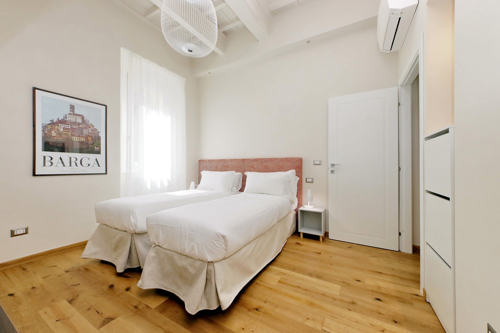 Bedroom 2 with two beds that can be combined to form one bed.