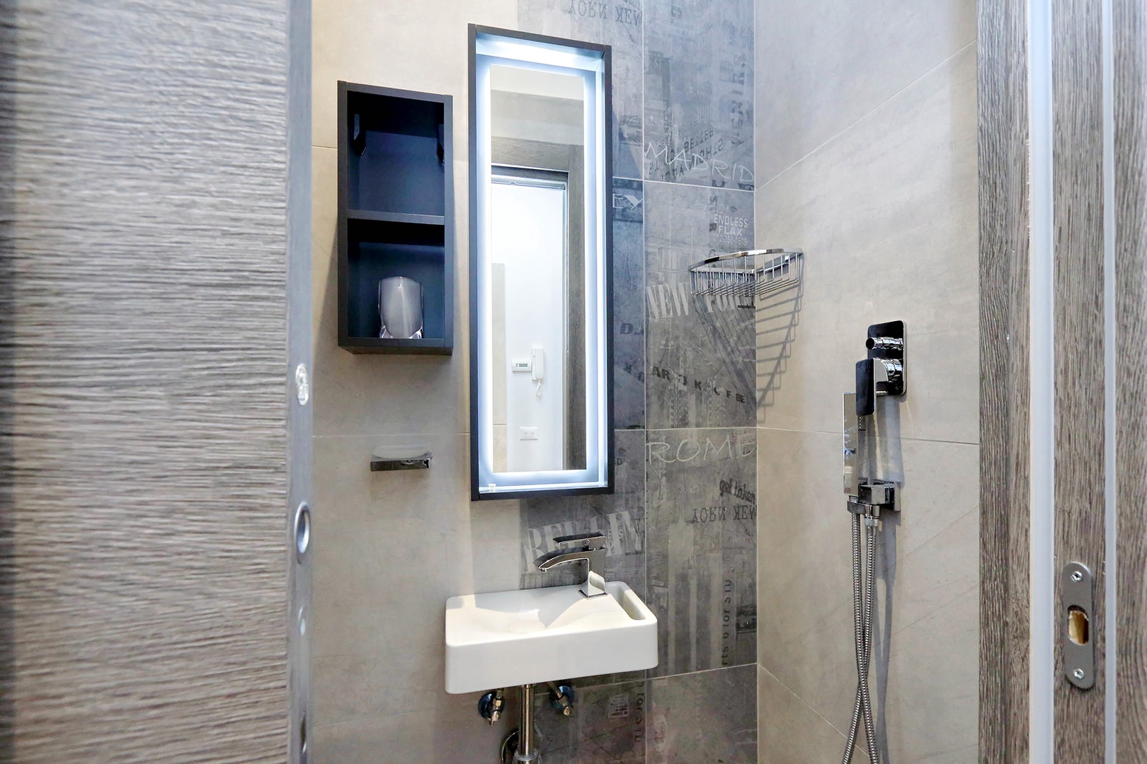 Bathroom 3 has an open shower, toilet and sink.