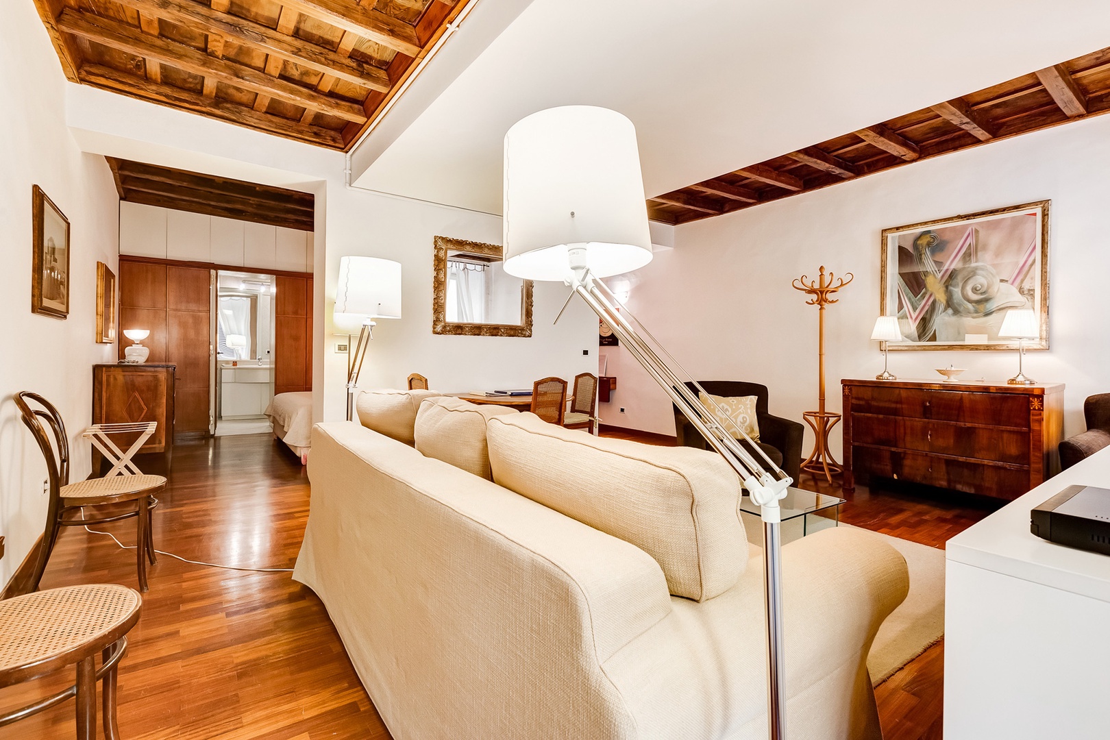 The bedroom is seen here just to the left of the dining table.