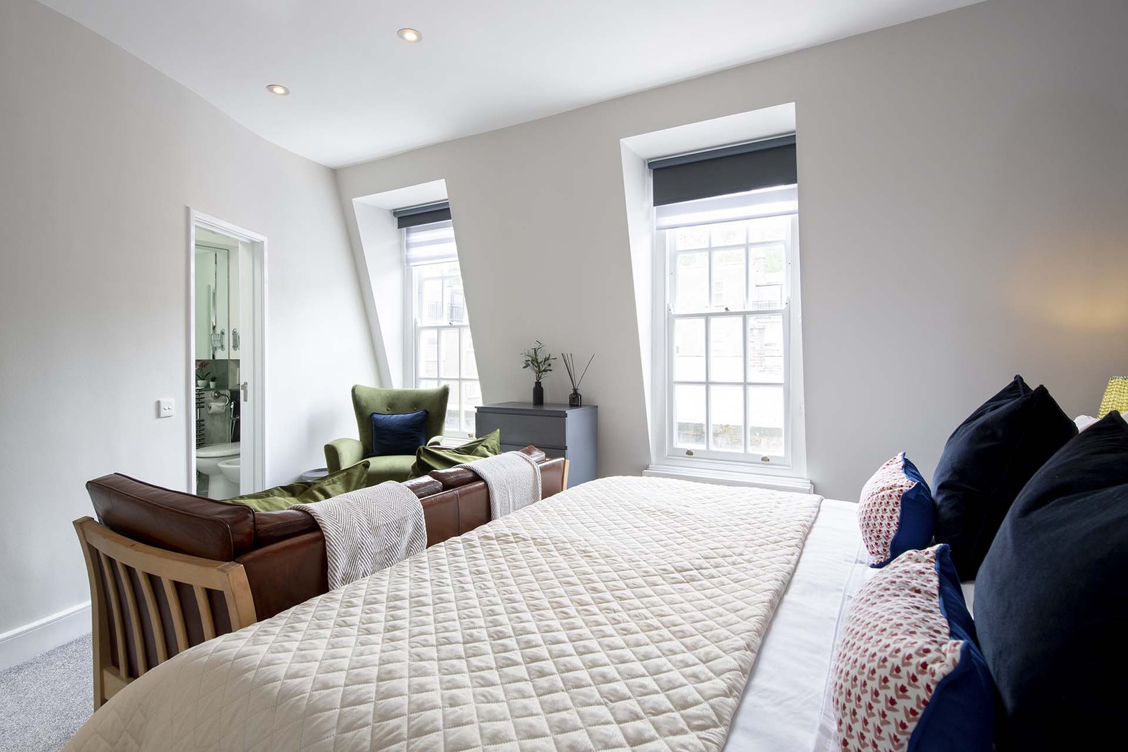 Bedroom 1 has a sofa and armchair.