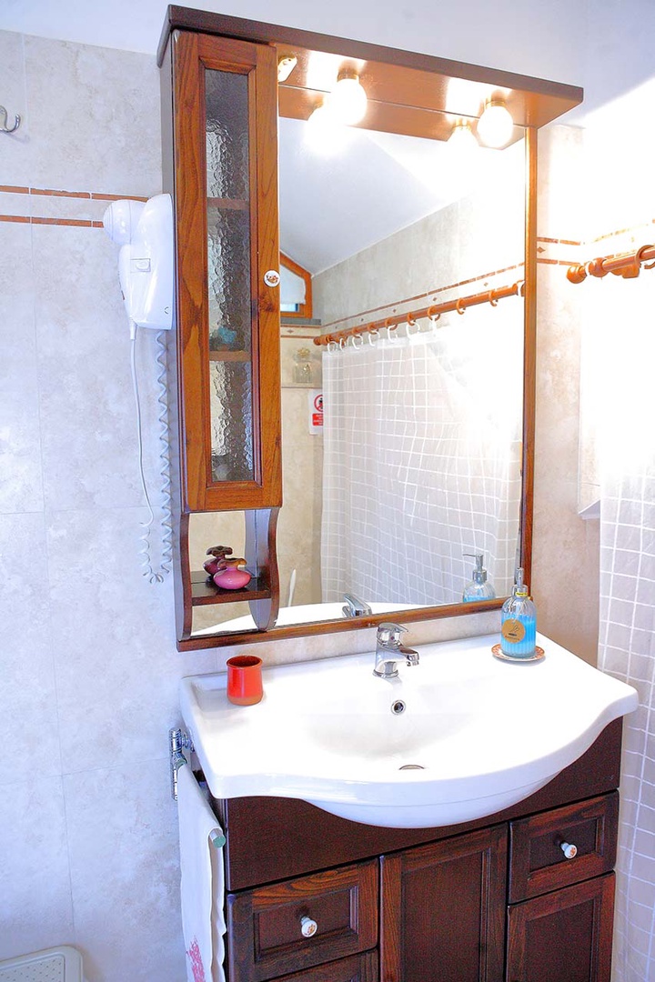 First floor bathroom with shower, toilet and sink.
