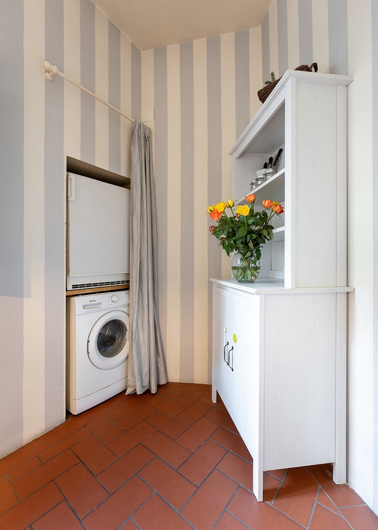 Pantry and washing machine in the kitchen.