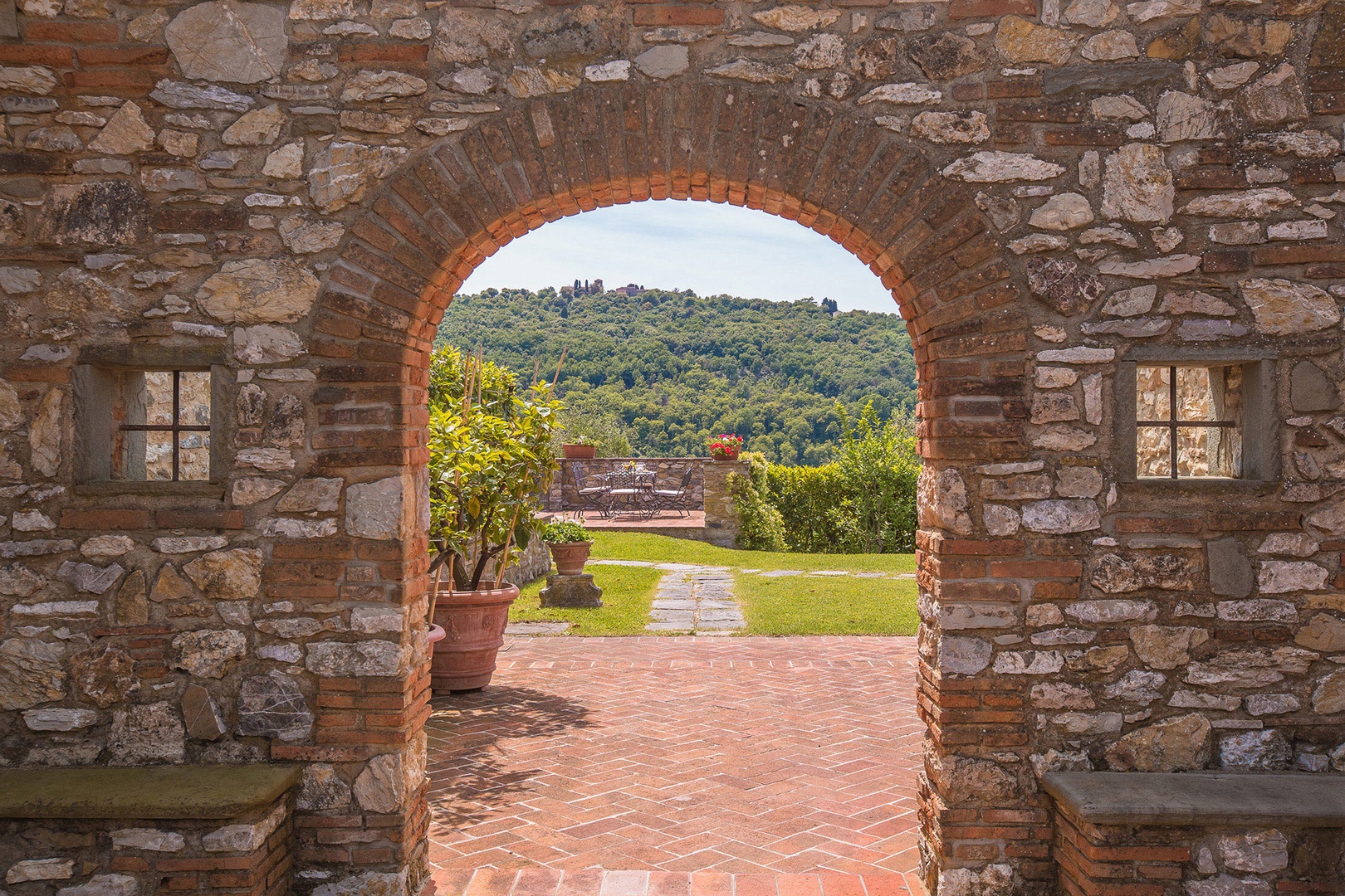 An archway frames another outdoor space where you can sit and enjoy the views.