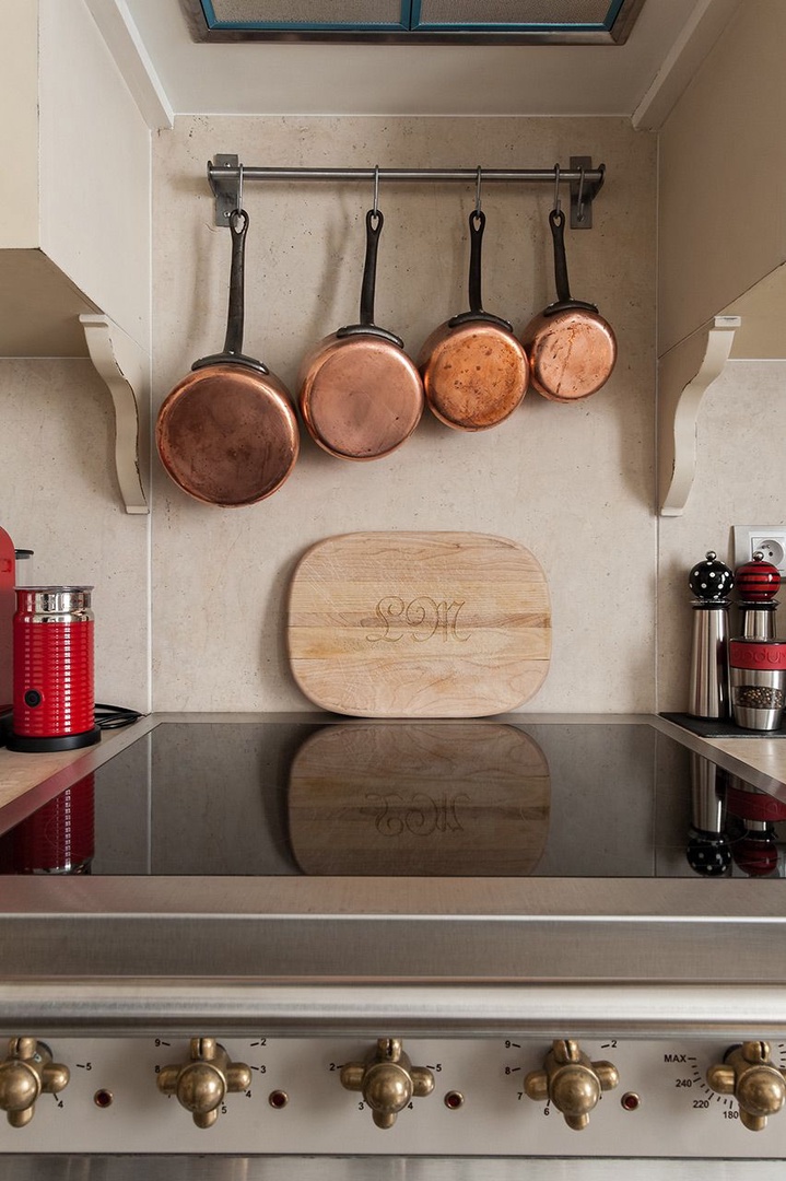 Copper pots create a French country feel in the kitchen.