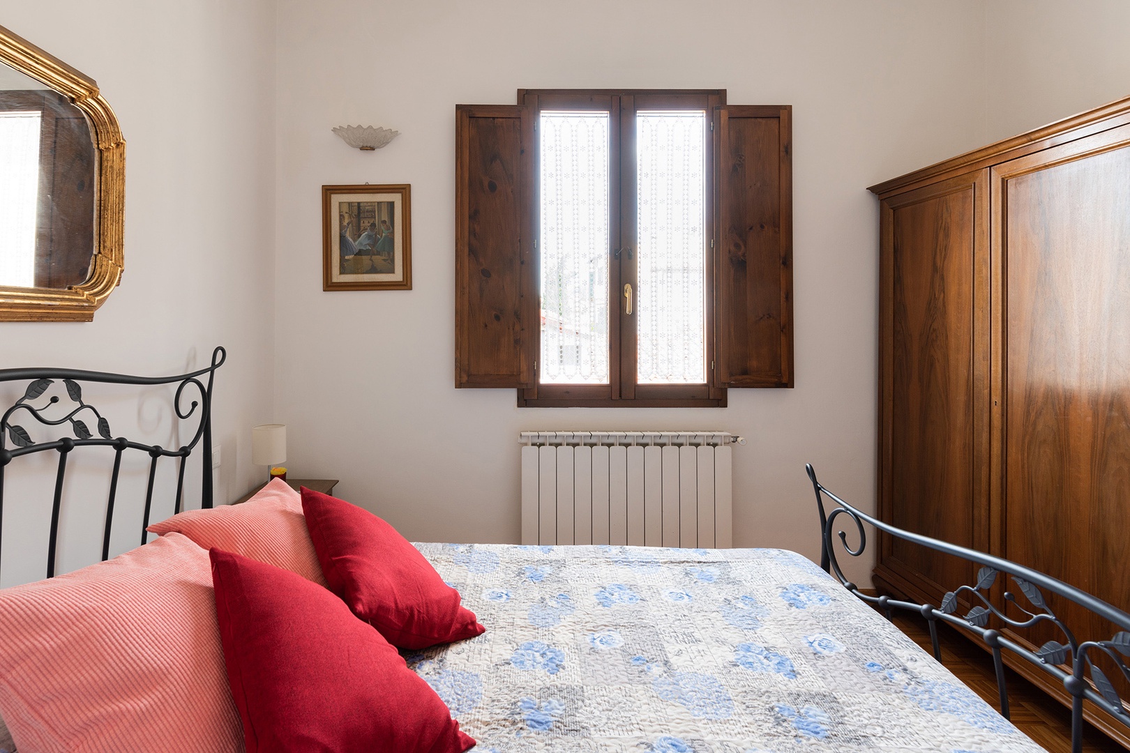 Large armoire in the bedroom provides ample clothing storage space.
