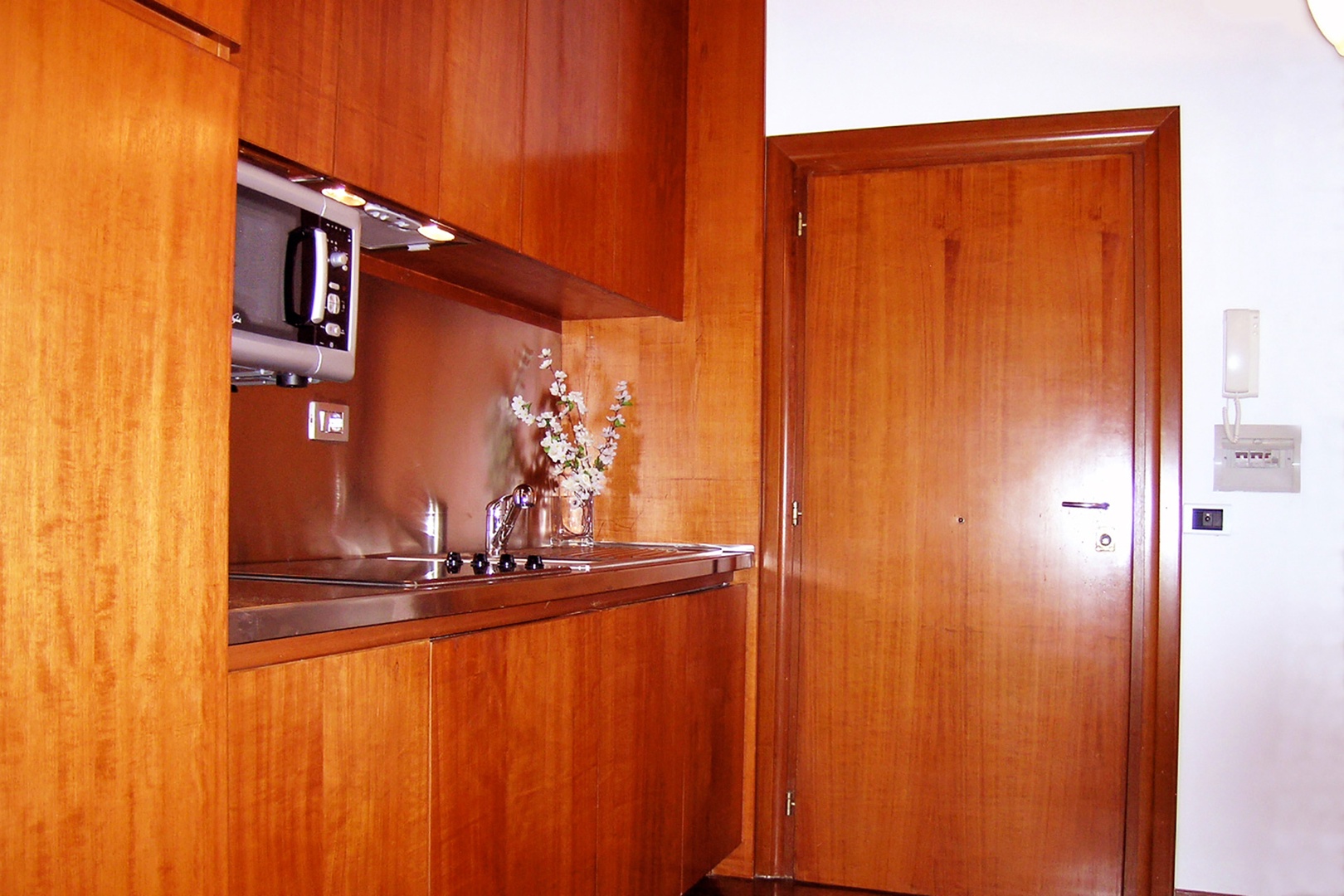 Enter the apartment front door and the kitchenette is immediately to your right.