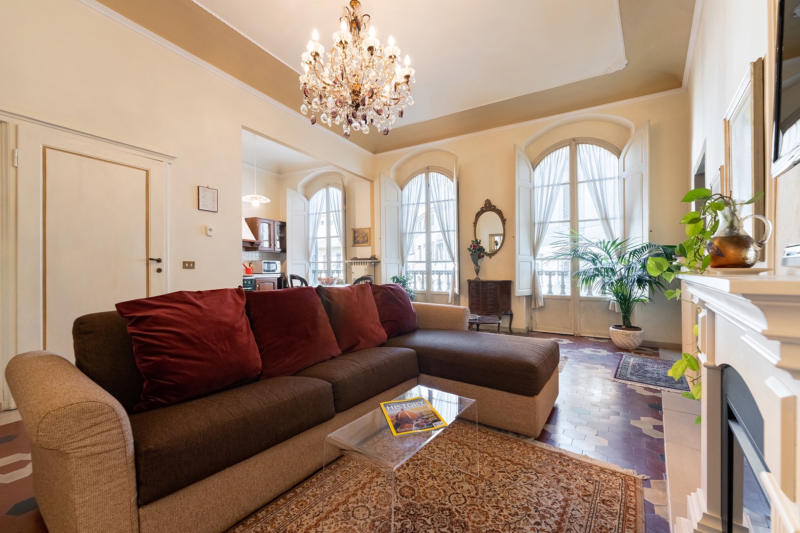 Three large windows illuminate the open plan living, dining room