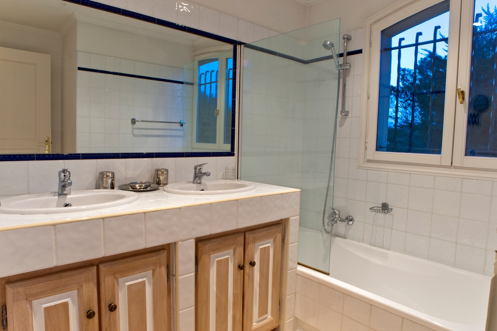 Bathroom three with bathtub with shower and double sink