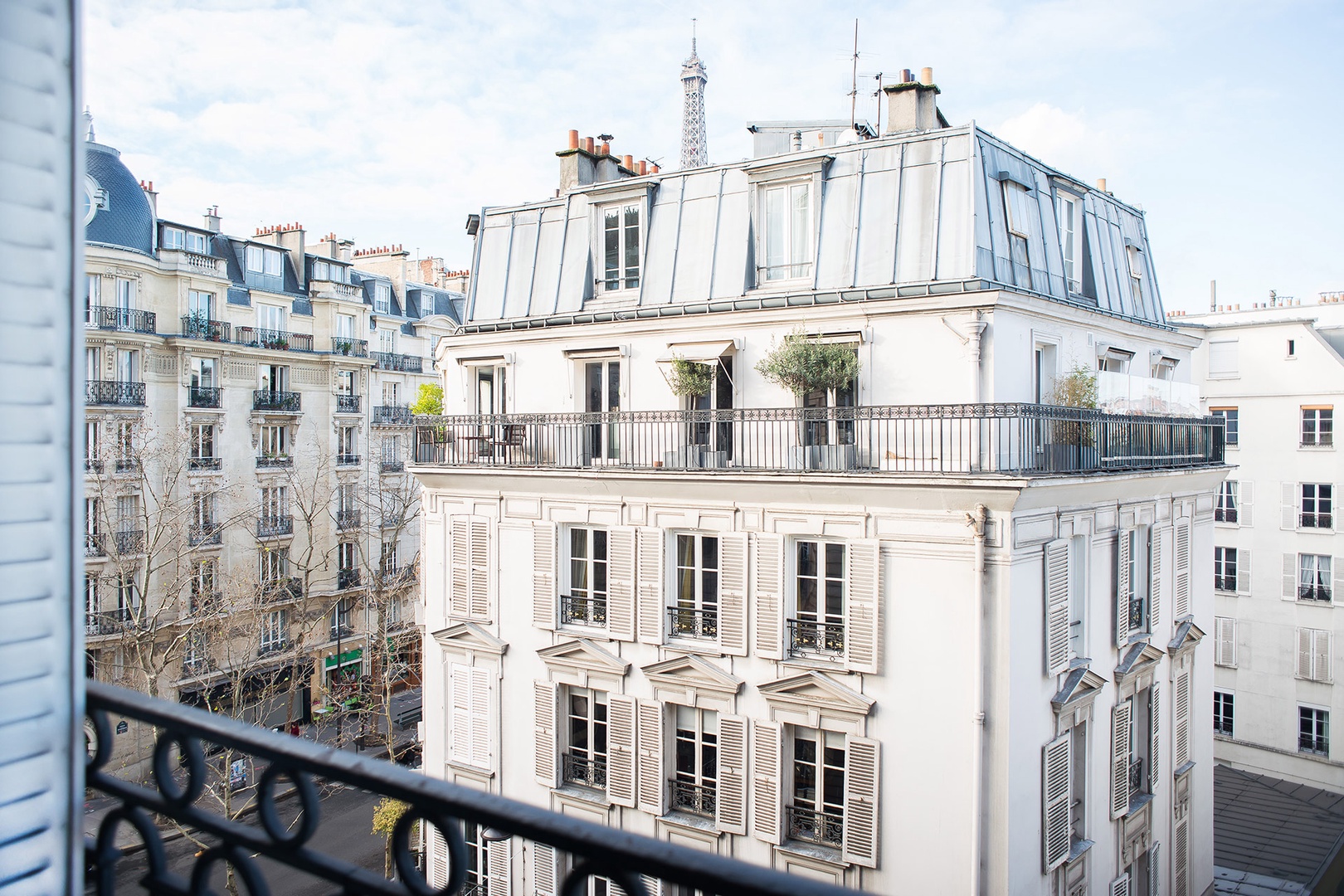 You'll have a gorgeous view of Parisian buildings and the Eiffel Tower.