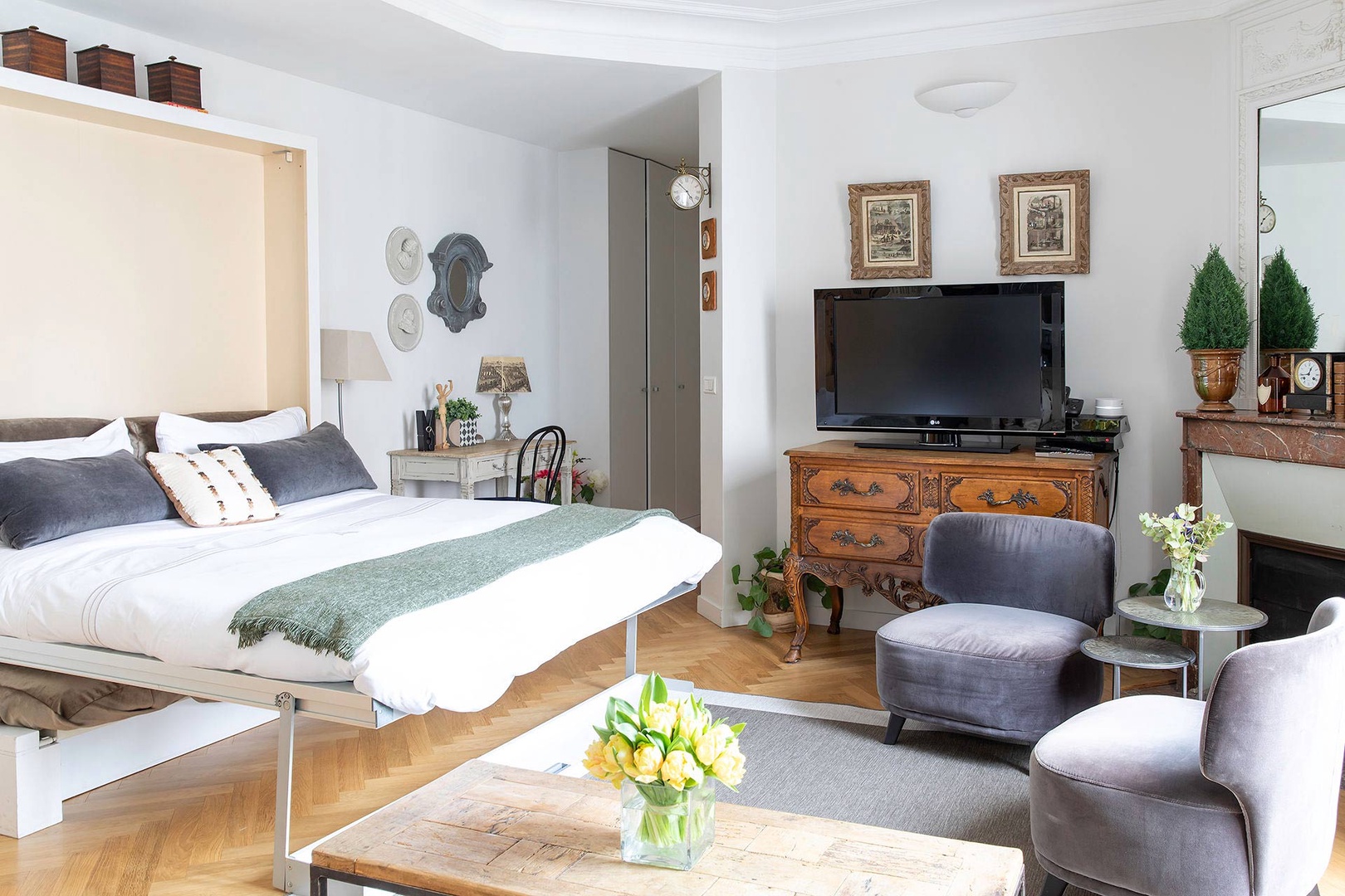 A wall bed folds down over the sofa for an additional sleeping space.