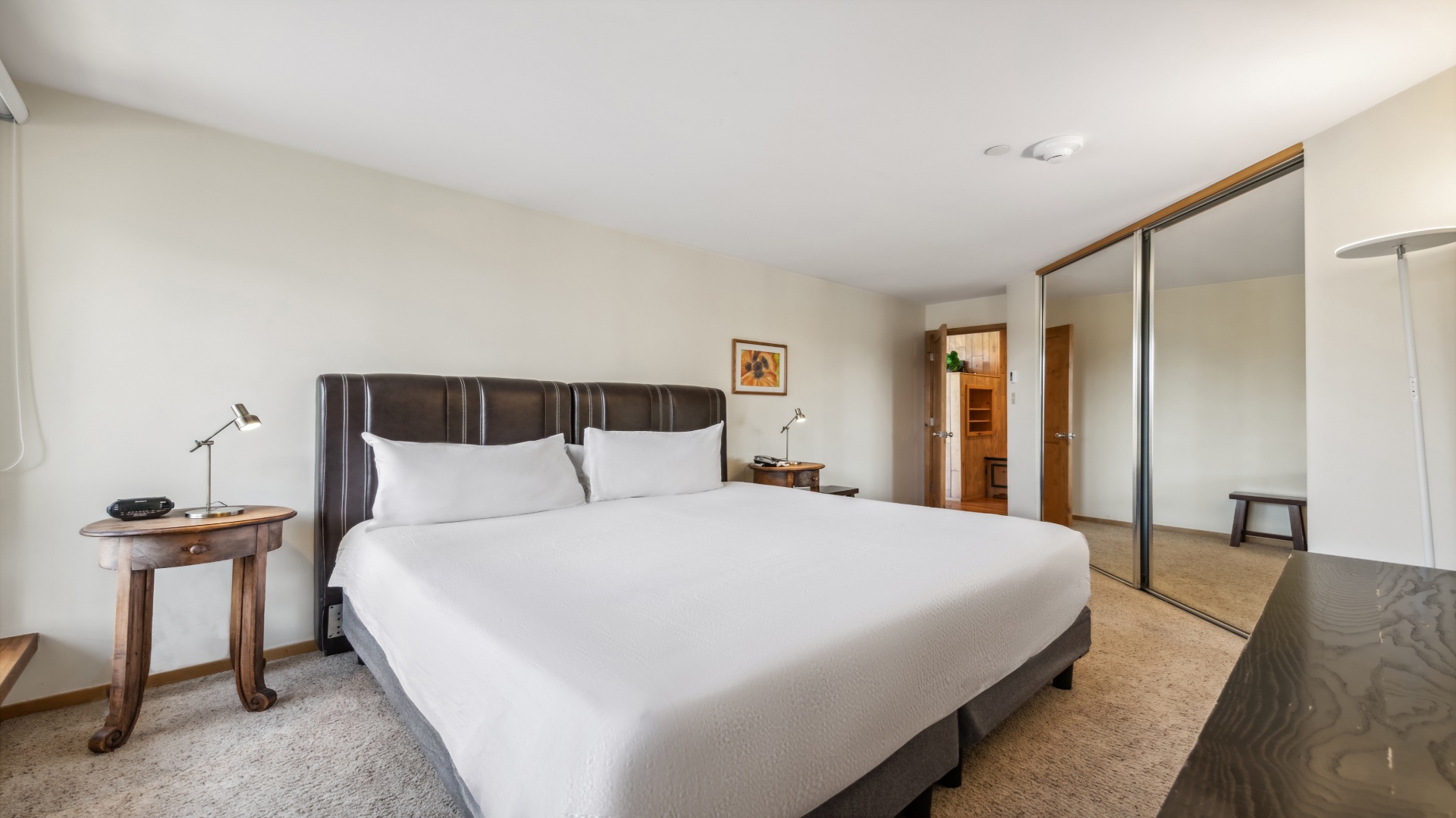 Unwind in your serene bedroom with a plush king bed, mirrored wardrobe, and cozy touches that invite restful nights and peaceful mornings.