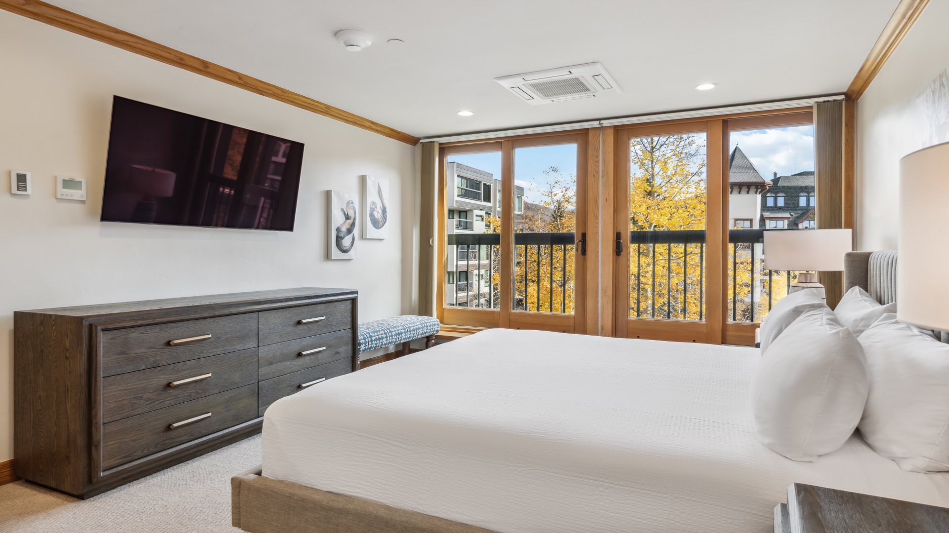 Picture yourself waking here, wrapped in crisp linens, with golden autumn foliage framing your view through floor-to-ceiling windows—your private retreat awaits.