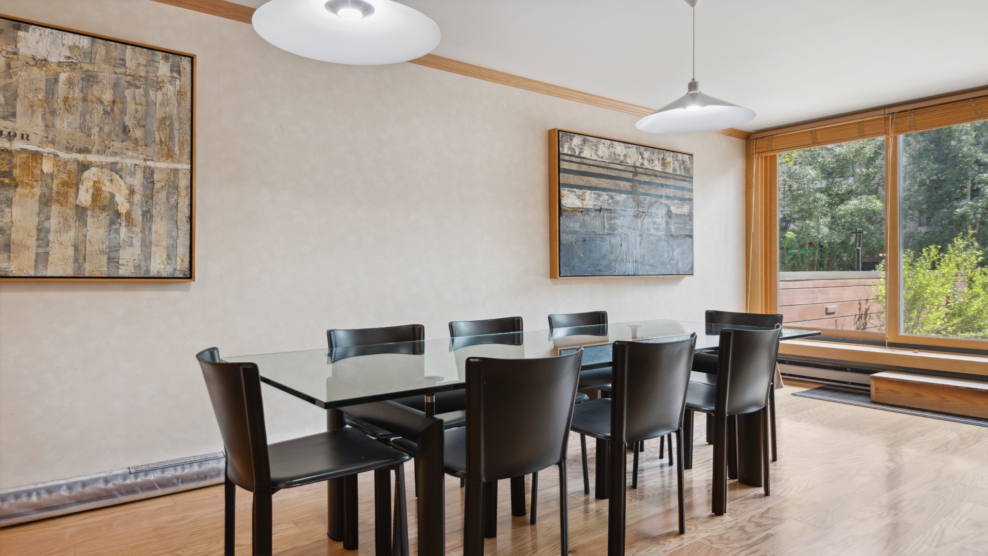 Gather around this elegant dining table for eight and enjoy meals with garden views through the large windows. The warm wood floors and artistic touches make every meal feel special.