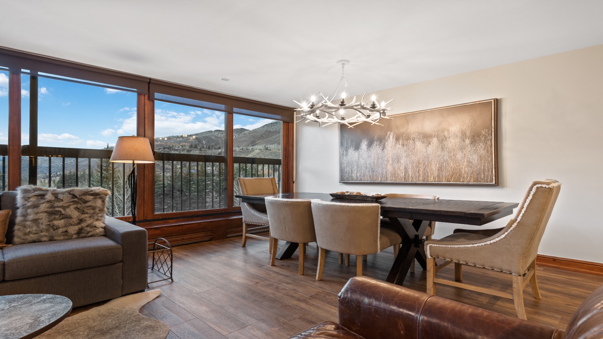 Gather around the elegant dining table and enjoy your morning coffee as stunning mountain vistas stretch before you through expansive windows—your perfect retreat awaits.