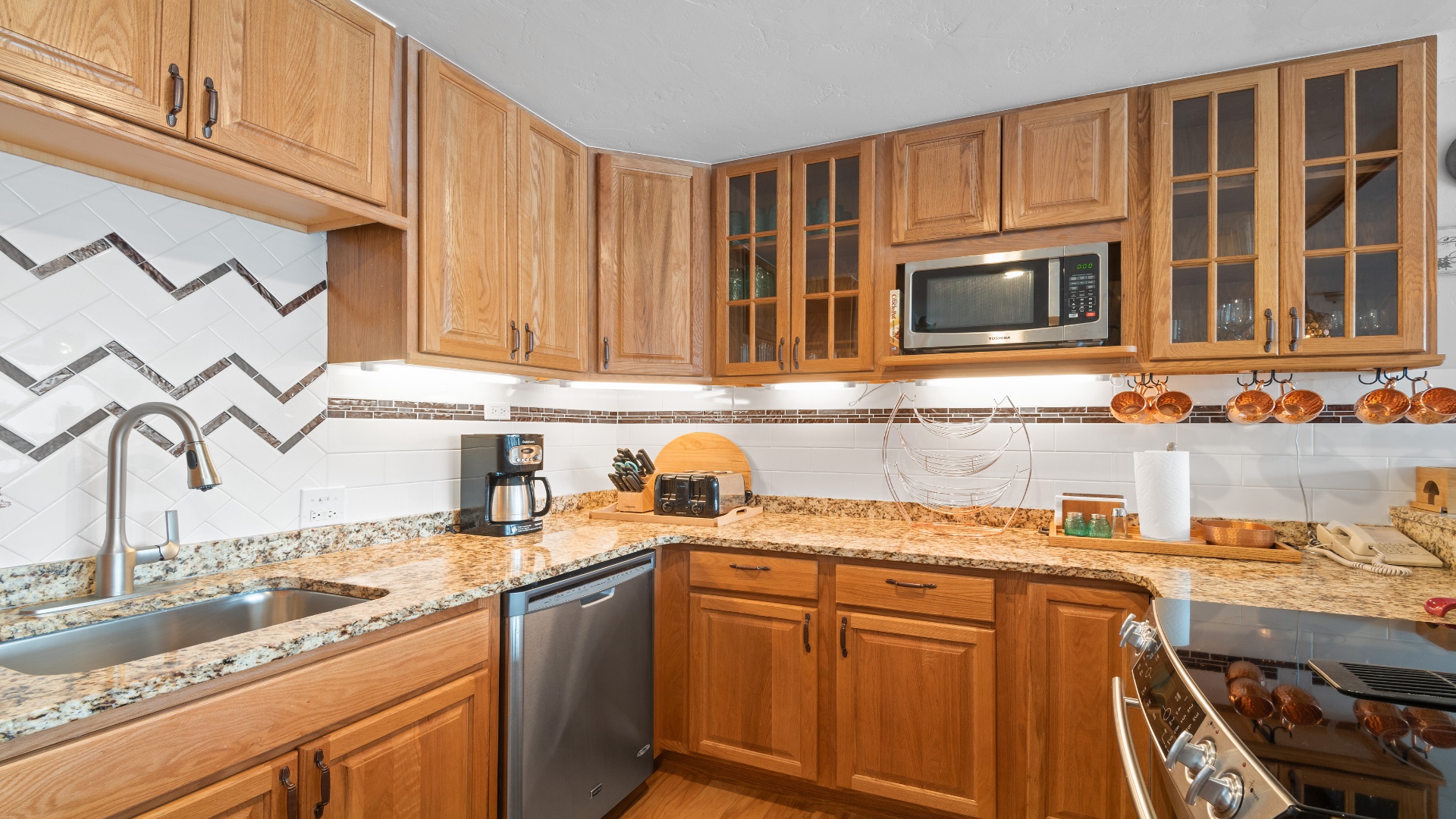 Your well-equipped kitchen awaits, complete with granite counters, stainless appliances, and ample cabinet space—perfect for preparing delicious meals together.