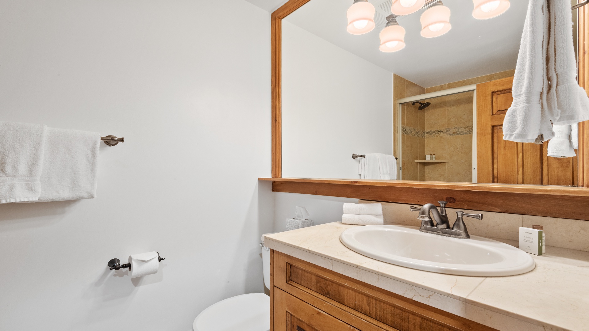 Step into your spotless bathroom featuring fresh towels, a spacious vanity, and a welcoming shower—your private retreat after a day of adventure.