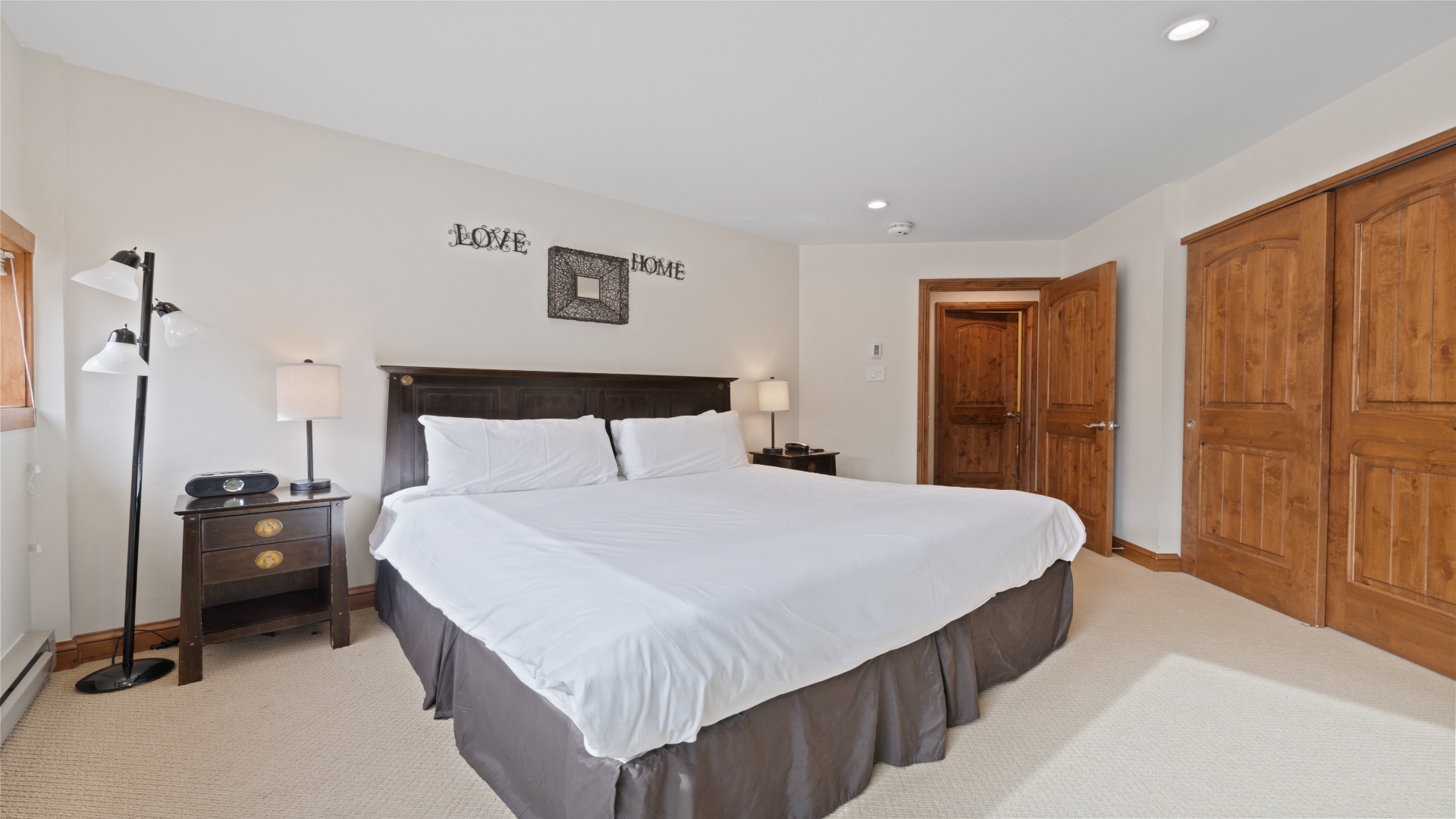 Sink into soft linens and enjoy your own peaceful retreat. With warm wood accents and thoughtful touches, this cozy bedroom invites restful nights and lazy mornings.