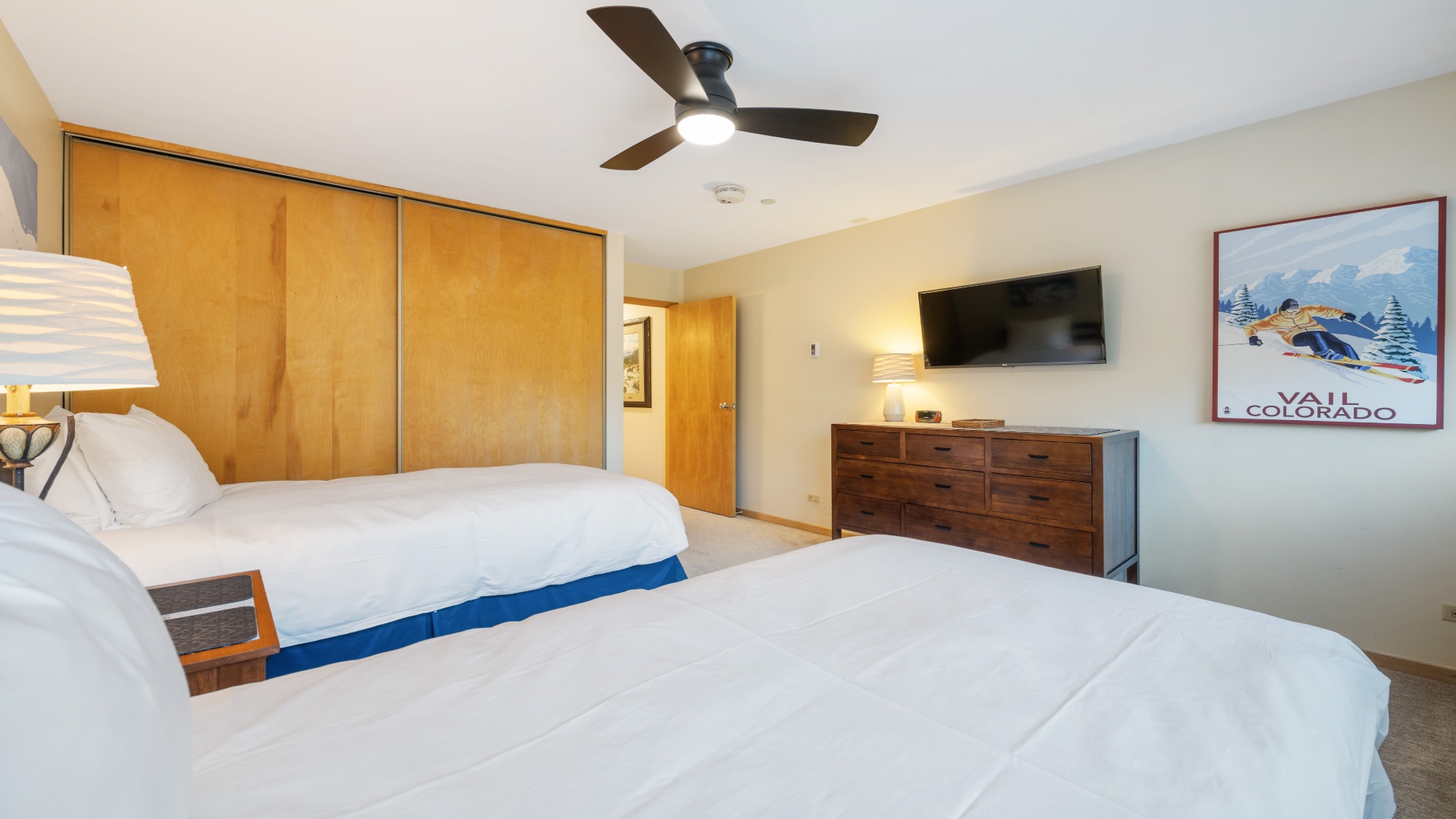Unwind in your cozy mountain retreat with plush beds, wood accents, and modern comforts, where crisp linens and warm lighting invite restful nights after your Colorado adventures.